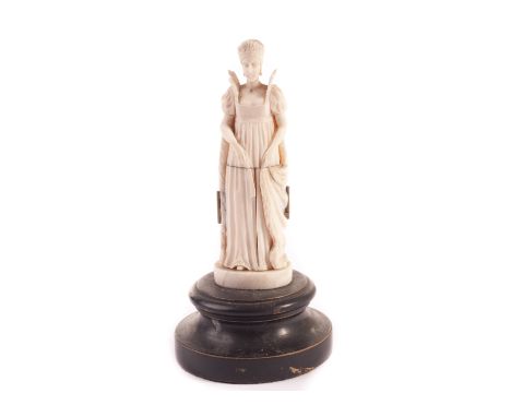 A Dieppe ivory devotional figure, modelled as Napoleon’s Josephine, her robes opening to expose scenes of piety, on round soc