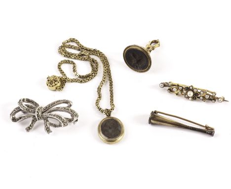 Five items of antique and vintage jewellery, including a fox hunting horn brooch, a seed pearl brooch, a mourning locket on c