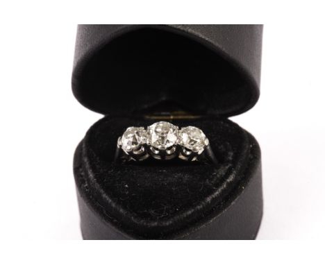 An early 20th century three stone diamond engagement ring, the three old cuts in claw settings (af) on a white 18ct setting a