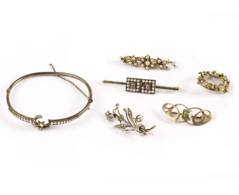 A group of five Victorian and later brooches and a bangle, one bar brooch with two panels of seed pearls centred with an old 