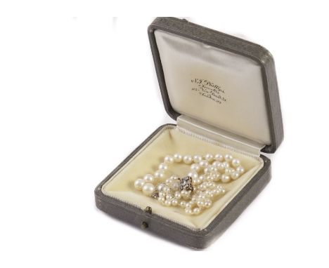 An Art Deco diamond graduated pearl necklace, knotted strung, with pierced diamond clasp, with an S.J Phillips grey leatheret