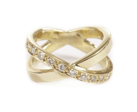 A modern stylish 18ct gold and diamond dress ring, having two intertwined bands, one set with eleven brilliant cuts, approx 7