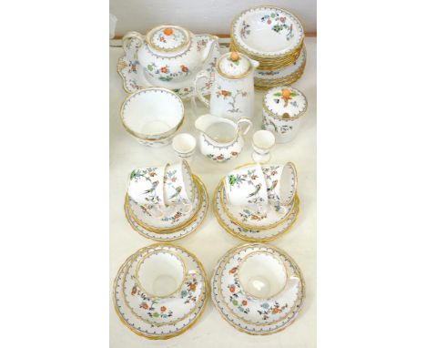 A TUSCAN CHINA TEA SERVICE, DECORATED WITH A BIRD AND STYLISED FLOWERS IN SHAPED GILT RIM, THE SERVICE INCLUDING TWO EGG CUPS