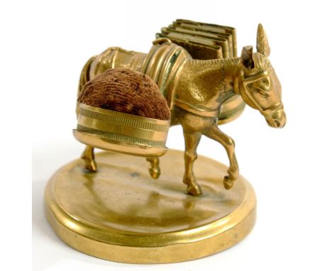 NEEDLEWORK TOOLS. AN UNUSUAL EMBOSSED BRASS SEWING COMPANION IN THE FORM OF A DONKEY, ONE OF ITS PANNIERS INCORPORATING A PIN