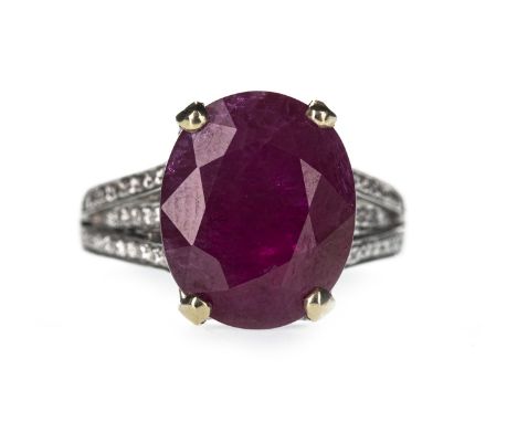 RUBY AND DIAMOND RING, set with an oval ruby of approximately 9.31 carats, on diamond set trifurcated shoulders, the diamonds