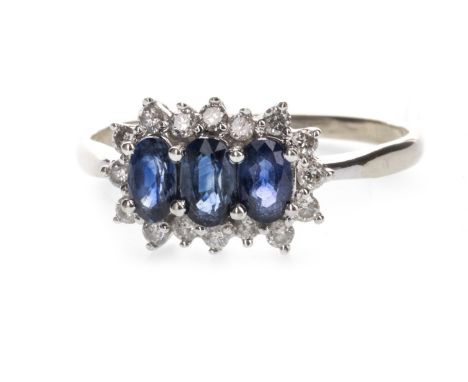 BLUE GEM AND DIAMOND RING, the three graduated blue gems surrounded by diamonds, marked 14KT