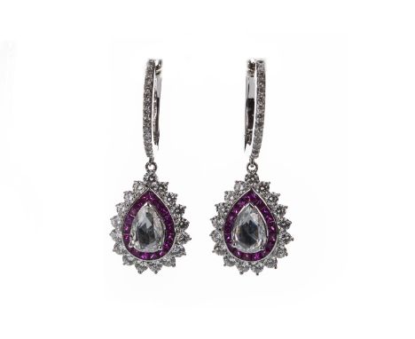 PAIR OF RUBY AND DIAMOND EARRINGS, each set with a rose cut pear shaped diamond bordered by calibre cut rubies within a round