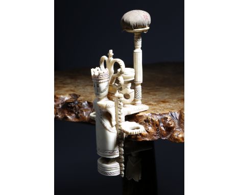 An early 19th century Napoleonic prisoner of war bone figural sewing table clamp, modelled with a Queen like figure wearing a