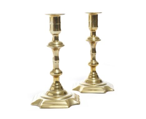 A pair of George II brass candlesticks by George Grove, each with a knopped stem and a domed base, the underside with a twist