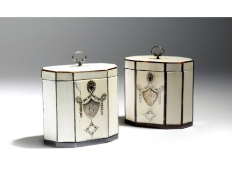 λ A near pair of George III ivory tea caddies, of octagonal shape, with tortoiseshell edging and inlaid with silver piqué wor