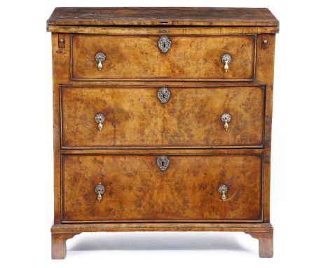 An early 18th century and later walnut bachelor's chest, burr veneered, the hinged fold-over top with cross and feather bandi