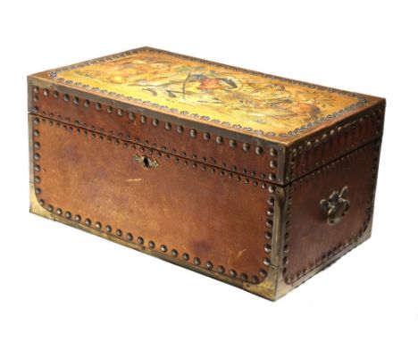 An oriental studded leather and brass bound trunk, the hinged lid decorated with knights jousting, with a castle and a sleepi