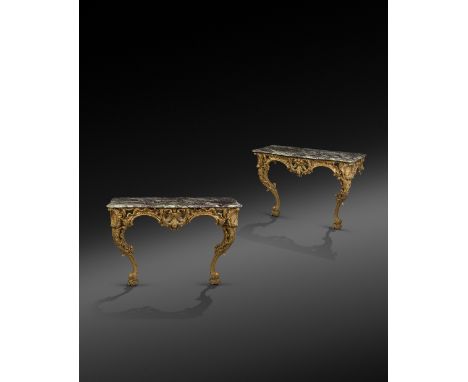 A pair of Italian Rococo giltwood console tables, each with a serpentine brèche violet marble top with a moulded edge, above 