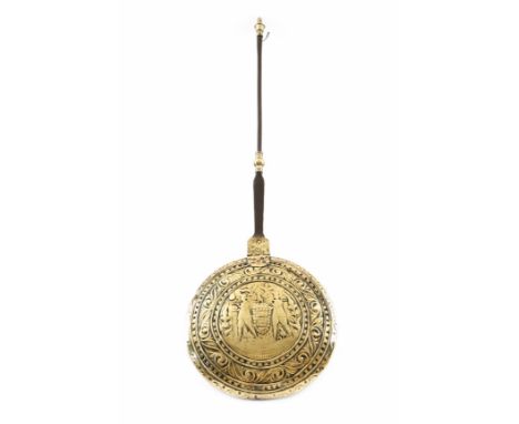 A 17th century Dutch brass warming pan, with an iron and brass handle with a turned urn finial, the pierced hinged lid repous