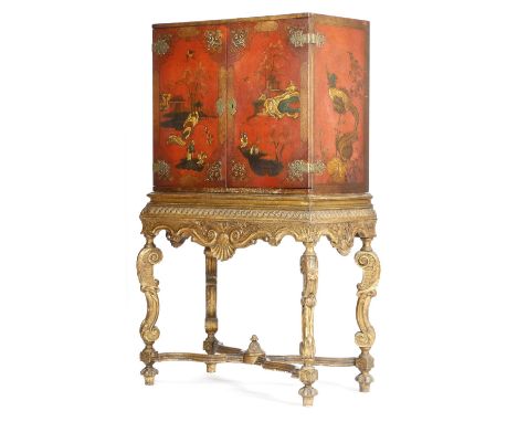 A red japanned and giltwood cabinet on stand in early 18th century style attributed to Tibbenham of Ipswich, decorated with c