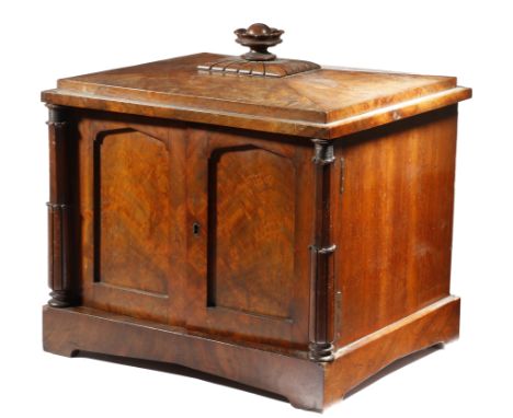 λ A George IV mahogany table coin collector's cabinet, with a stylised urn finial above a pair of arched panelled doors, flan