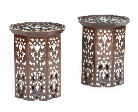 A pair of Moorish hardwood octagonal occasional tables, inlaid with mother of pearl flowers and with pewter stringing, the to