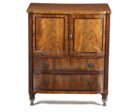 An early 19th century mahogany barrel front cabinet, with ebonised decoration, fitted with a pair of panelled cupboard doors 