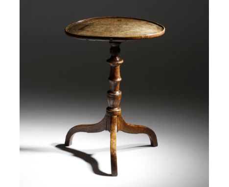 A late George III burr elm tripod table, the dished top on a reeded and vase turned stem and scroll legs, 64.8cm high, 47.3cm