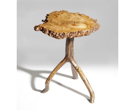 A primitive burr wood table, the rustic ash top on a tripod branch base, probably 19th century, 48.3cm high, 44cm wide. Prove