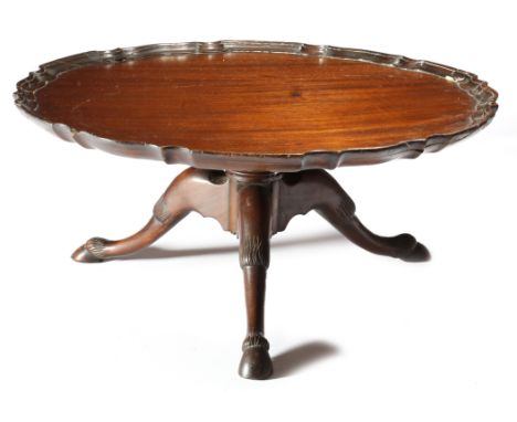 A late Victorian mahogany lazy susan, in the form of an 18th century tripod table, the revolving top with a pie crust edge, o