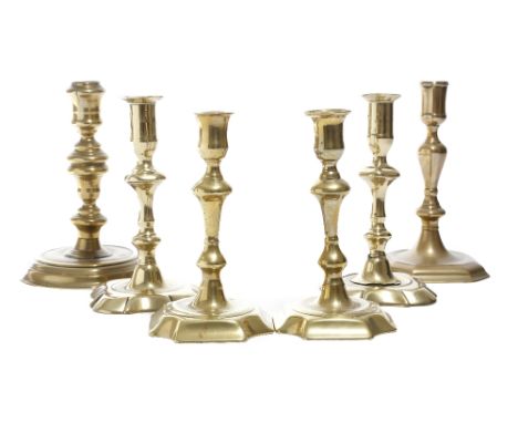 Two pairs of George II brass candlesticks, each with a knopped stem, together with a Queen Anne candlestick, with a turned ba