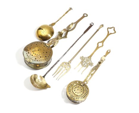 Three brass chestnut roasters, with pierced decoration and hinged lids, one 18th century with a turned handle, the largest st