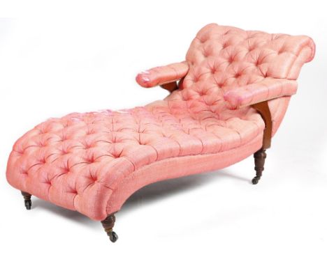 A late Victorian walnut day bed in the manner of Howard &amp; Sons, button upholstered in pink fabric, on turned legs and cer