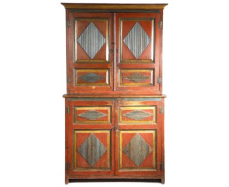 A 19th century Baltic painted pine cupboard, with ribbed lozenge fielded panels, the top with a pair of cupboard doors enclos