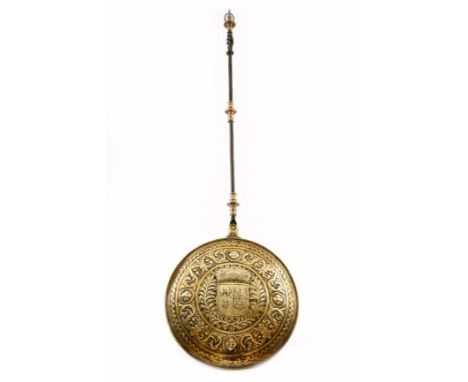 A 17th century Dutch brass warming pan, with a steel and turned brass handle, the pierced hinged lid repoussé decorated with 