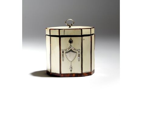 λ A George III ivory octagonal tea caddy, with tortoiseshell stringing and mother of pearl dot inlay, with a silver ring hand