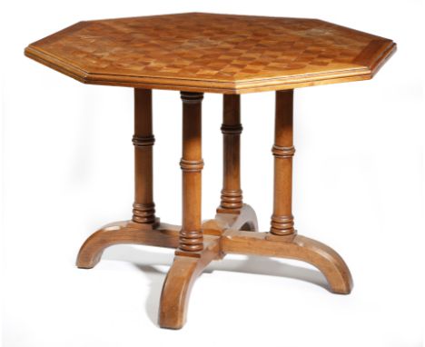 A late Victorian walnut octagonal centre table by James Shoolbred &amp; Co., in Gothic style, the parquetry top crossbanded a