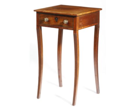 A Regency mahogany lamp table, inlaid with ebonised stringing, the crossbanded top above a frieze drawer, on moulded sabre le