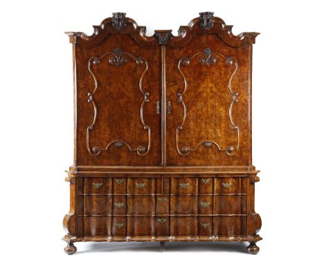 An 18th century Dutch burr walnut armoire, with elm banding, the twin arched cornice with three leaf and scroll carved vase h