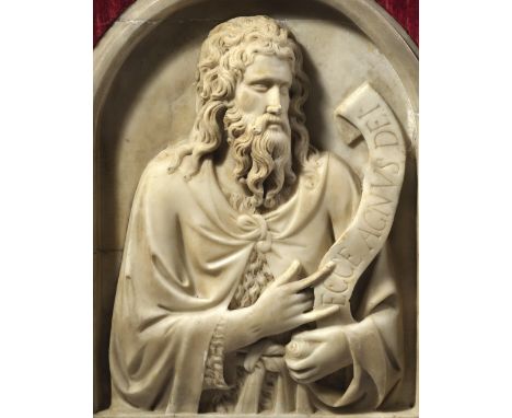 An Italian marble relief of St. John the Baptist after Tino di Camaino (c.1285-1337), depicting the saint wearing a cloak ove