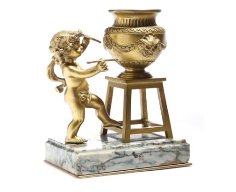 A late 19th century French ormolu inkwell, modelled with a cherub painting an urn, with a ceramic liner, on a moulded marble 