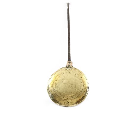 A Charles II brass warming pan, with an iron handle, the pierced hinged lid engraved with the Vintner's arms and inscribed th
