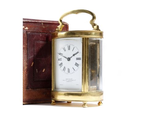 A French gilt brass oval carriage clock, with a platform lever escapement, the enamel rectangular dial with Roman numerals an