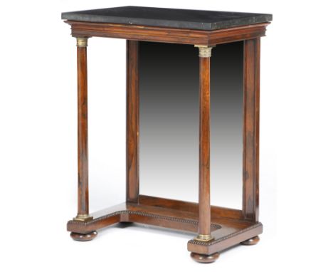 λ A Regency rosewood console table, the black marble top supported by a pair of turned columns with anthemion and engine turn