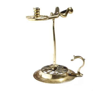 A George III brass wax jack, with a scissor action holder with a dished pan, the pierced base with a scroll thumbpiece, the u