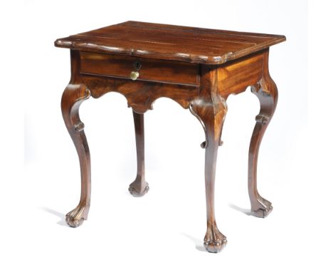 A South African Cape Dutch stinkwood low occasional table, the moulded edged top with a shaped front, above a frieze drawer, 