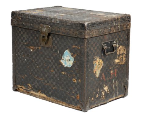 A Louis Vuitton travelling trunk, covered in damier chequered canvas, with metal and brass mounts, inscribed 'MARQUE L. VUITT