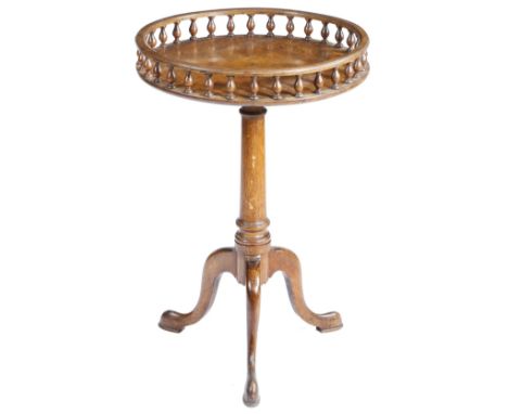 A walnut tripod table in George II style, the burr veneered top with a baluster gallery, on a turned stem and cabriole legs w