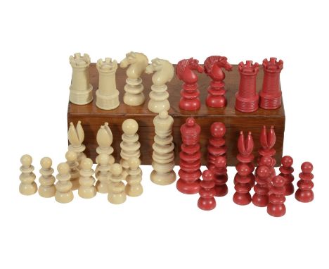 An ivory chess set, in natural and stained red, with turned pieces, thirty-two pieces, some (AF) in wooden box
