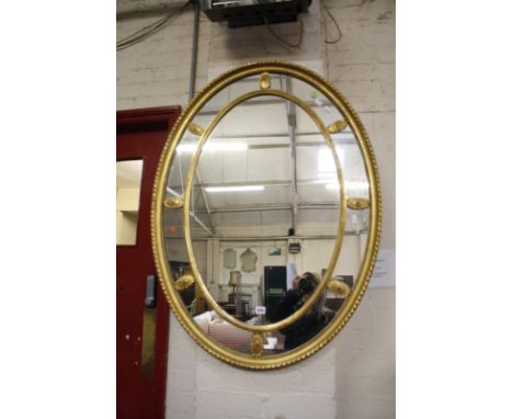 A Georgian style marginal oval gilt mirror with inner ring of patera.111cm x 81cm.