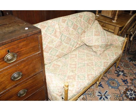 A bentwood conservatory sofa with removable cushions.