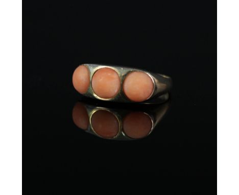 A 9ct gold ring set with three coral stones, size R