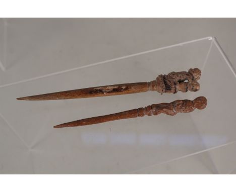 Two Roman carved wood cloak pins with erotic decoration