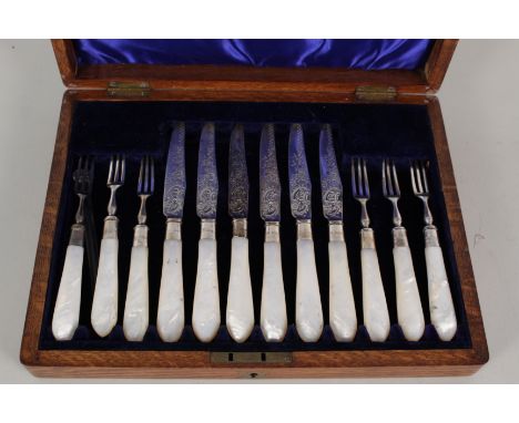 A set of six mother of pearl handled silver fruit knives and forks (the blades appear to be replacements as hallmarks on blad