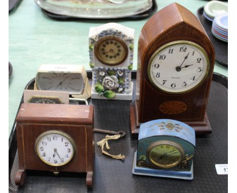 An Edwardian inlaid mahogany mantel clock plus various others and four caricature prints